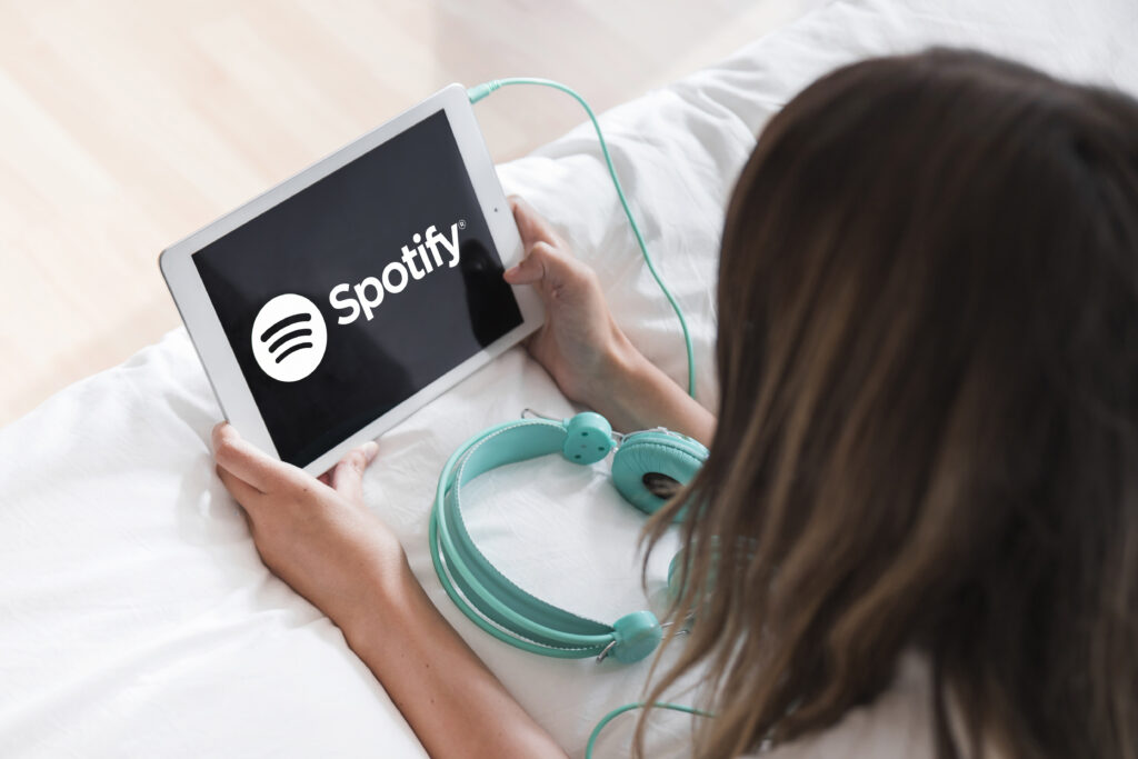 young woman holding tablet with spotify app (1)